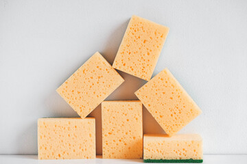 Yellow sponges on a white background. Copy, empty space for text