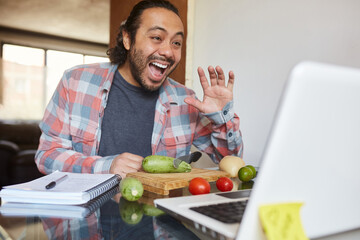Young mature man taking cooking classes online