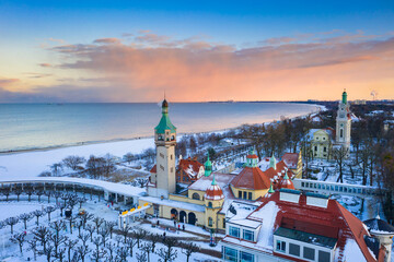 Fototapeta premium Beautiful sunset over the snowy beach and pier (Molo) in Sopot at winter. Poland