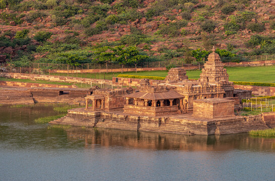Badami, Karnataka, India - November 7, 2013: Closeup of Bhootnath Temple on east shore of Agasthya Lake. Reddish rock hills in back under sunset twilight. 