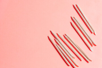 Set of cosmetic tools for manicure and pedicure on a orange background. Manicure sticks top view.
