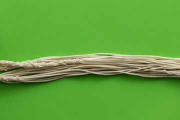 Tallit threads made of sheep wool, green background