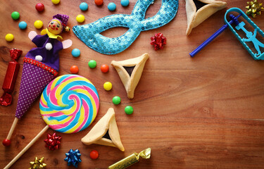 Fototapeta premium Purim celebration concept (jewish carnival holiday) over wooden background. Top view, flat lay