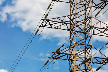 Metal mast for the transmission of high voltage electricity against the blue sky.