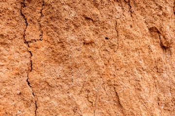 Detail and texture of the earth of a slope with cracks.