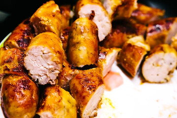 fried sausage with an appetizing crust on a white plate. dish for the festive table.