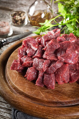 Beef stew prepared on a chopping board.