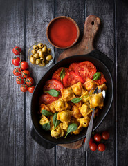 ravioli with tomatoes and cheese. Parmesan cheese. in a plate. Top view