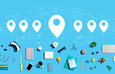 Map pin concept with collection of electronic gadgets and office supplies
