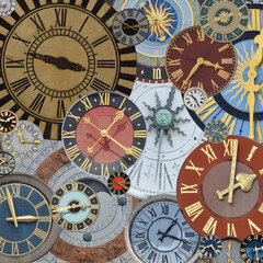 Fototapeta na wymiar multicolored collection of ancient church tower clocks on a pile in different sizes and forms with roman numbers