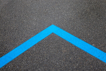 blue parking strips on asphalt road