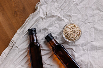 Pine nut cake in a bowl and a bottle of oil. Waste from the dairy. After the squeezed out oil. Useful vitamins. Raw crushed butter in a glass bottle with raw materials. cold pressed