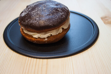 Chocolate cake with a cut piece and blade on gray background, closeup