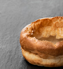 Fresh baked Yorkshire pudding on stone background