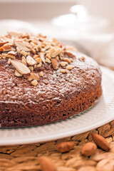 Almond cake on a white plate close-up. Almond flour baked goods without sugar, gluten free, healthy dessert concept