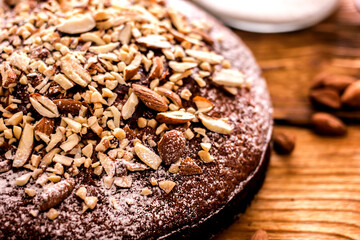 Almond cake on a white plate close-up. Almond flour baked goods without sugar, gluten free, healthy dessert concept
