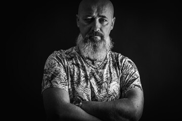 Fototapeta premium close up, portrait of emotional, thoughtful, handsome positive young bearded businessman man. Low key isolated on dark background. Body language 