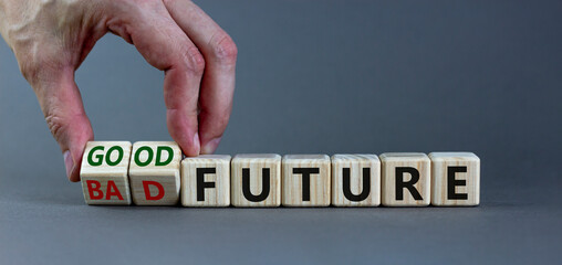 Good or bad future symbol. Businessman turns wooden cubes and changes words 'bad future' to 'good...