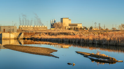 Fort Saint Vrain Generating Station near Plateville, Colorado, originally built as a nuclear power plant, currently powered by natural gas, distant view with St Vrain Creek in front