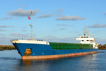 Blue hulled general cargo ship on a bright sunny day 