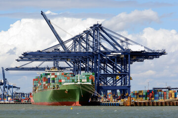 Container ship unloading at a busy port