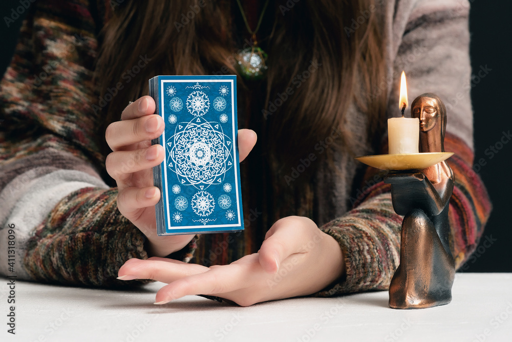 Wall mural fortune teller is reading the future with tarot cards close up.