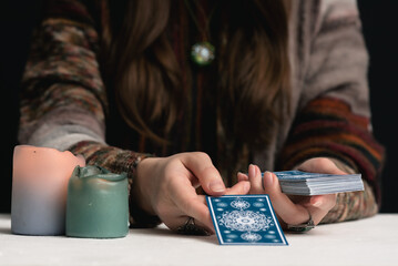 Fortune teller is reading the future with tarot cards close up.