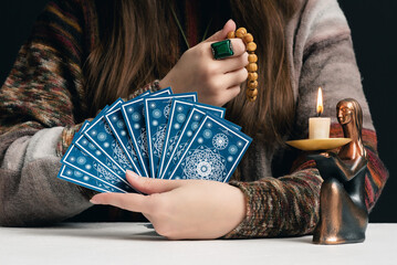 Fortune teller is reading the future with tarot cards close up.