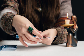 Fortune teller is reading the future with tarot cards close up.