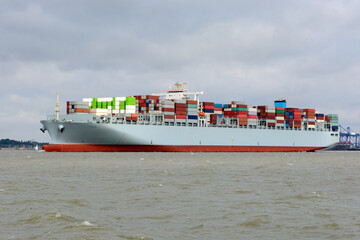 Big conatiner ship full of containers outbound from port.