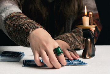 Fortune teller is reading the future with tarot cards close up.