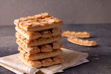 Puff pastry cakes with glaze. On a blue background.