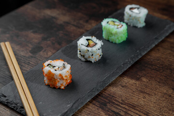 maki on gray plate and wooden table
