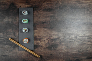 maki on gray plate and wooden table © jonarrillaga