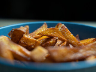 homemade serving of fries. French fries in a bowl on a wooden table.