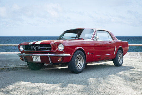 BARCELONA, SPAIN-FEBRUARY 2, 2021: 1965 Ford Mustang GT Hardtop (first generation) next to sea