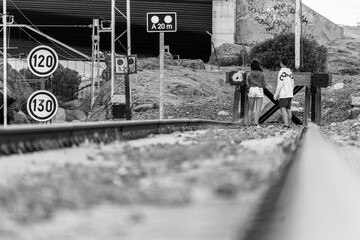 Avila, Spain; 06.18.2019: Young couple at a train track end