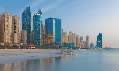Fototapeta na wymiar Dubai - The evening skyline of Marina hotels from beach.