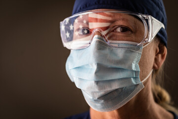 American Flag Reflecting on Female Medical Worker Wearing Protective Face Mask and Goggles