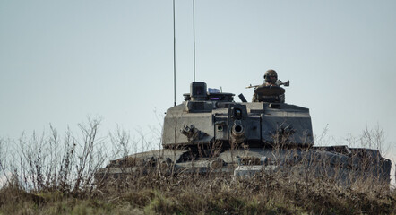 Fototapeta premium Action shot of a British army Challenger 2 FV4034 main battle tank on military exercise, Salisbury Plain UK