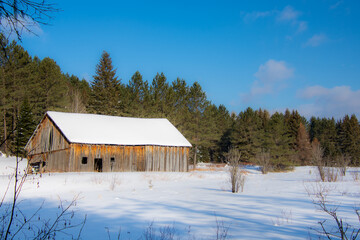 Old barn in a field during Quebec winter in Canada