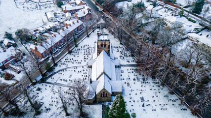 Aerial view of St Johns Church Hartford North with Cheshire in Winter snow. Hartford is a village and civil parish in Cheshire West and Chester.