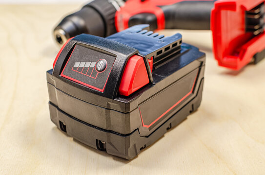 Electric drill or cordless screwdriver with battery, recharge battery.
