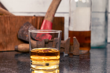 Glass of Bourbon Whiskey - Neat - in front of vintage tools