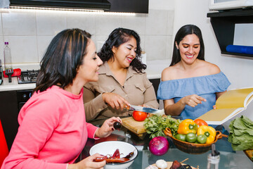 Three hispanic Female Friends cooking vegetables in a mexican Kitchen Together in Latin America