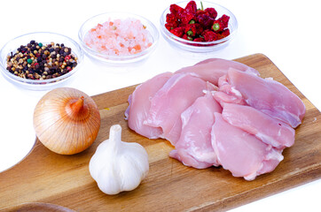 Fresh raw pink eco chicken fillet for cooking on white plate. Studio Photo