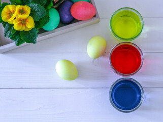 colorful chicken eggs, colorful Easter eggs on the white table