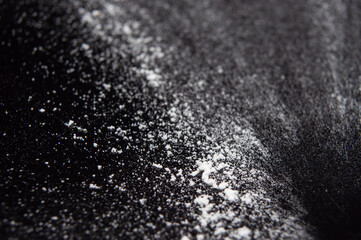 white flour on a black background, texture