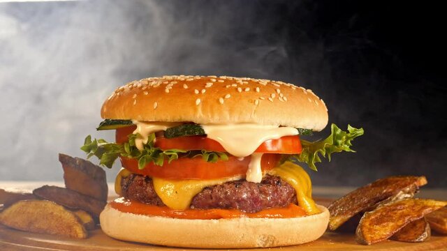Smoke clouds envelop a tasty burger with crispy countrylike potato 