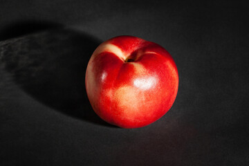 white nectarine on black background